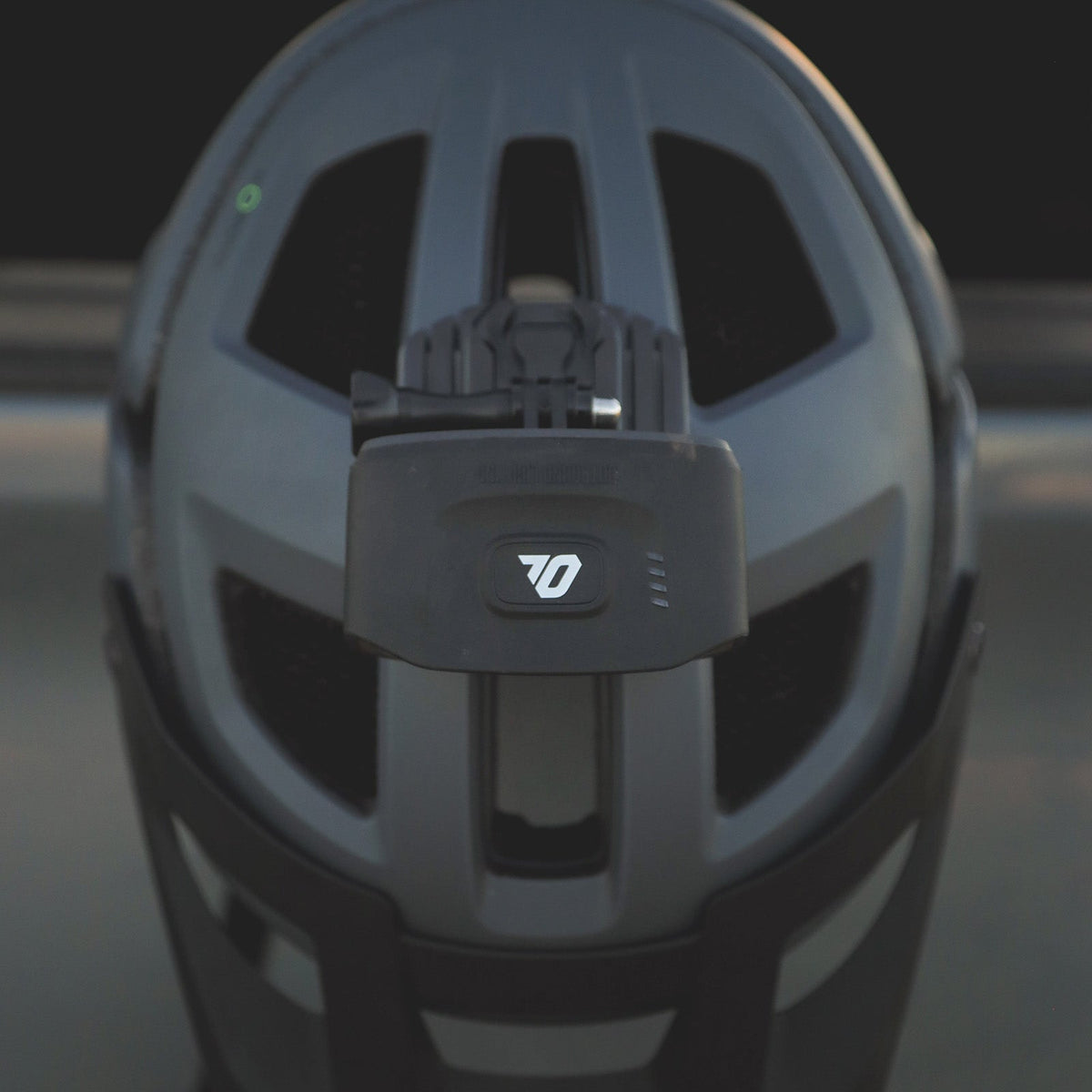 Portal bike helmet light mounted on a black mountain bike helmet, seen from behind