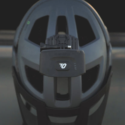 Portal bike helmet light mounted on a black mountain bike helmet, seen from behind