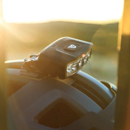 Portal bike helmet light mounted on a helmet at sunset, side view